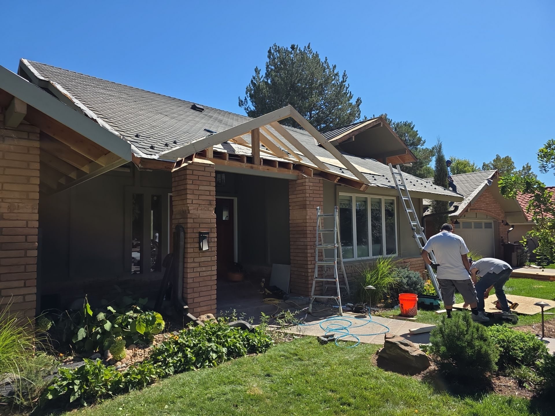 Crew framing the new gable structure over the main entrance, Boulder CO