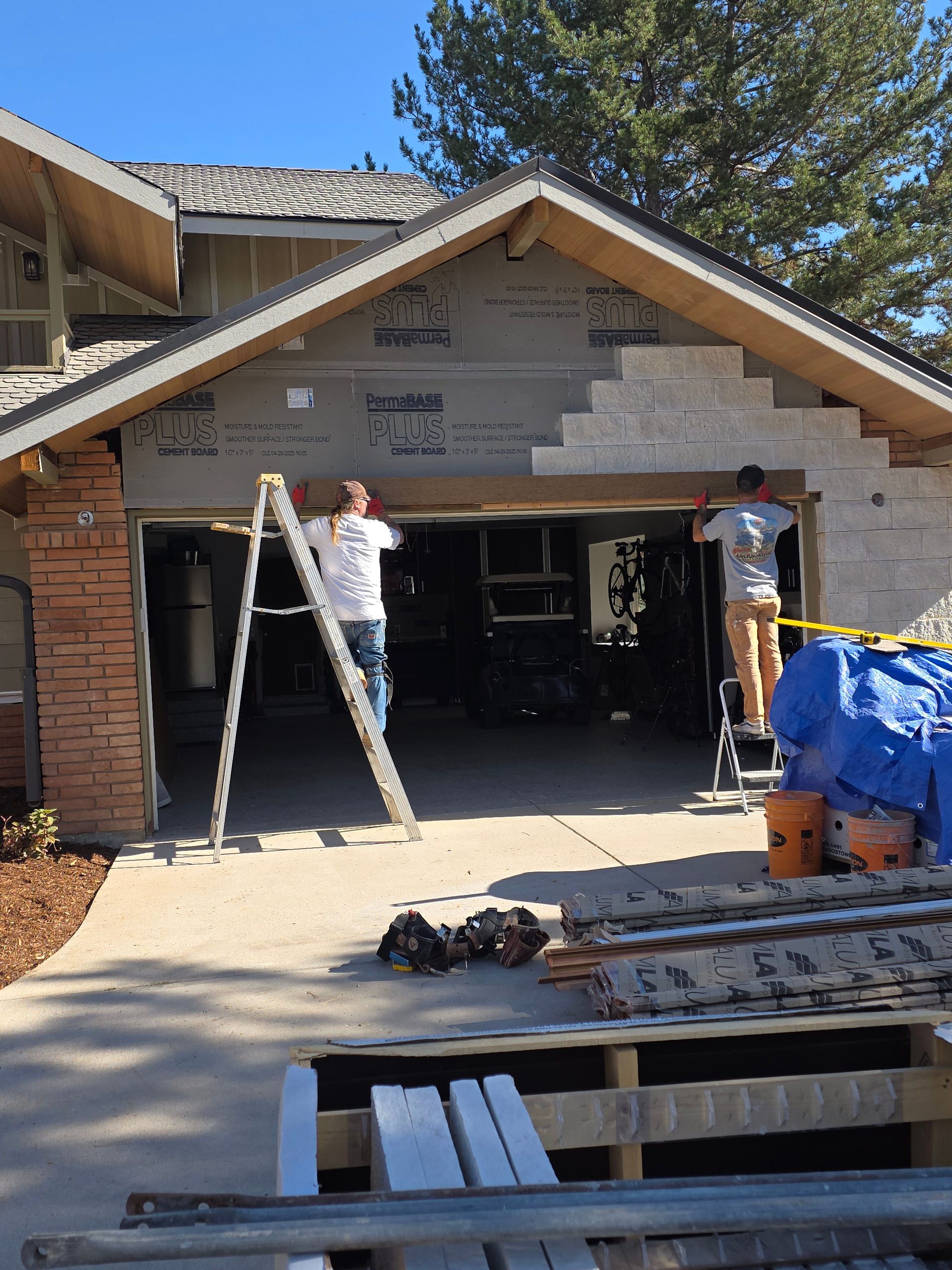 Installing El Dorado stone veneer around the garage opening, Boulder CO